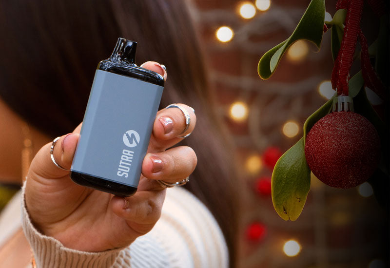 Woman holding Sutra SILO Pro near mistletoe and ornament