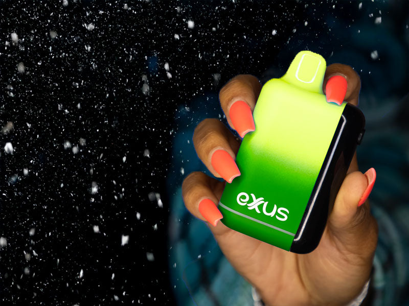 woman with blue flannel holding the Exxus Snap DLX 510 Battery with snow falling down